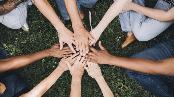 Several hands overlap
