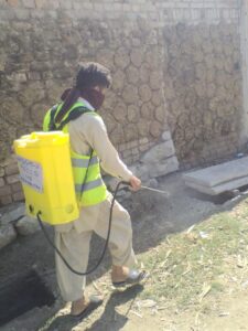 man spraying street