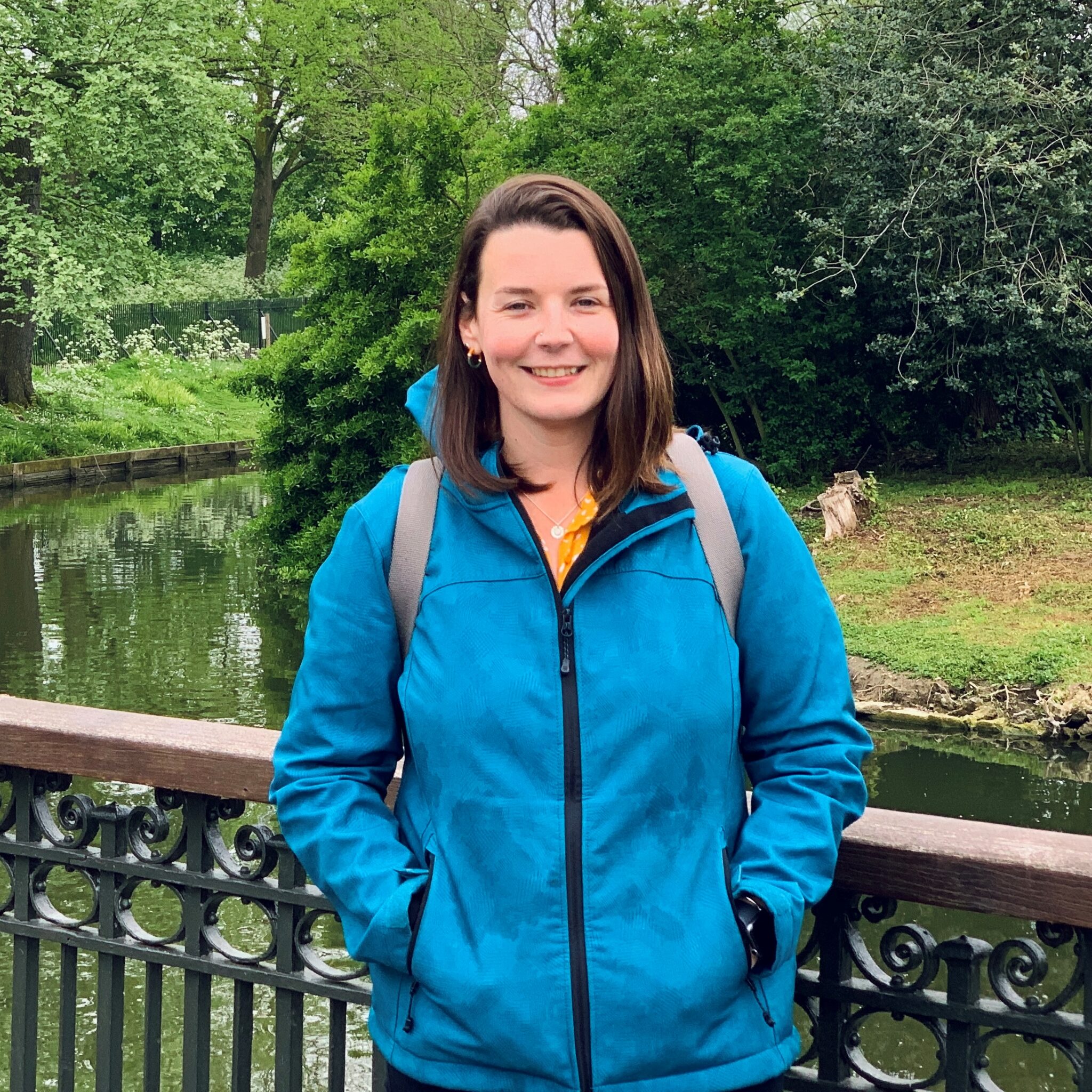 Alice standing in front of pond